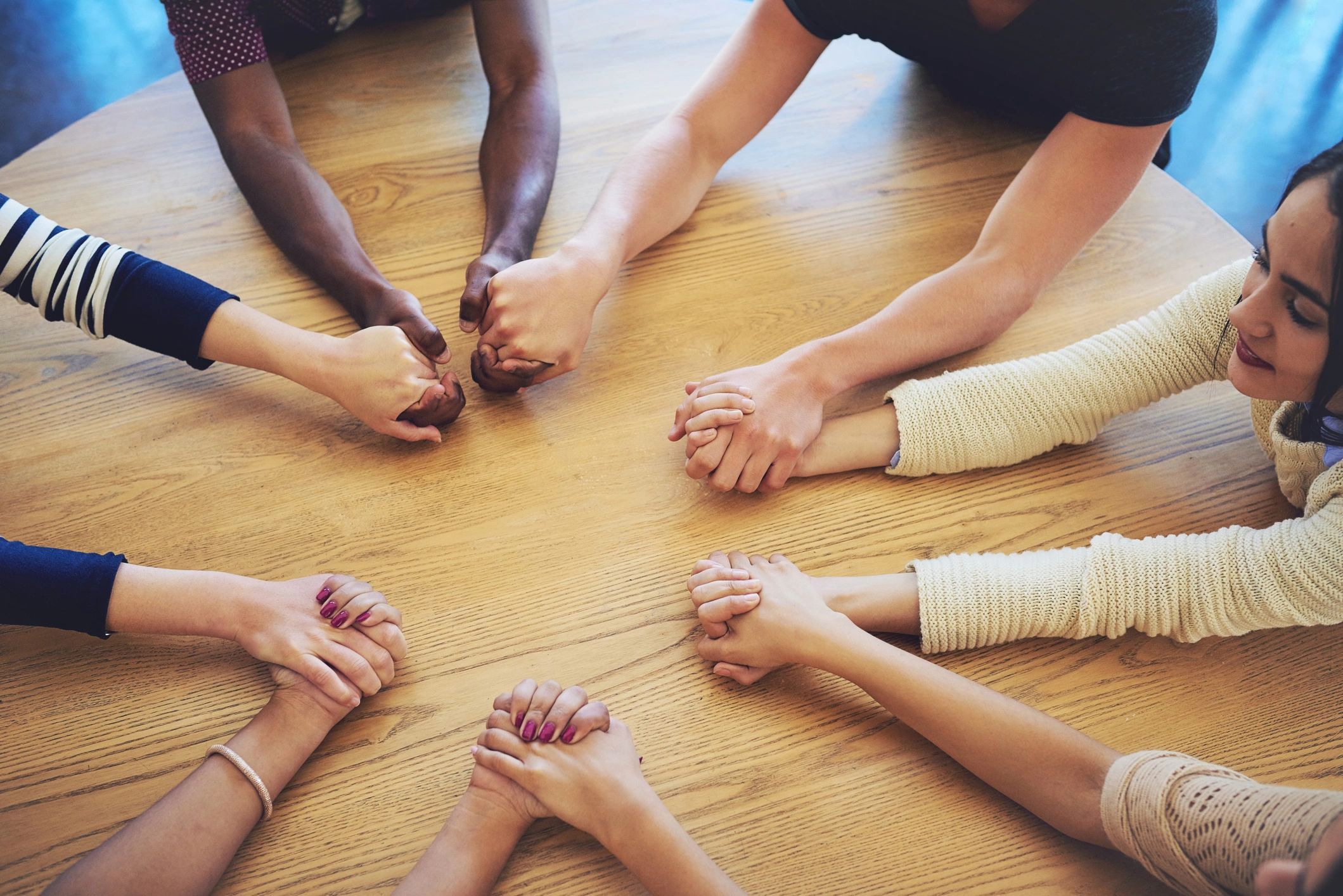 Friends joining hands in fellowship