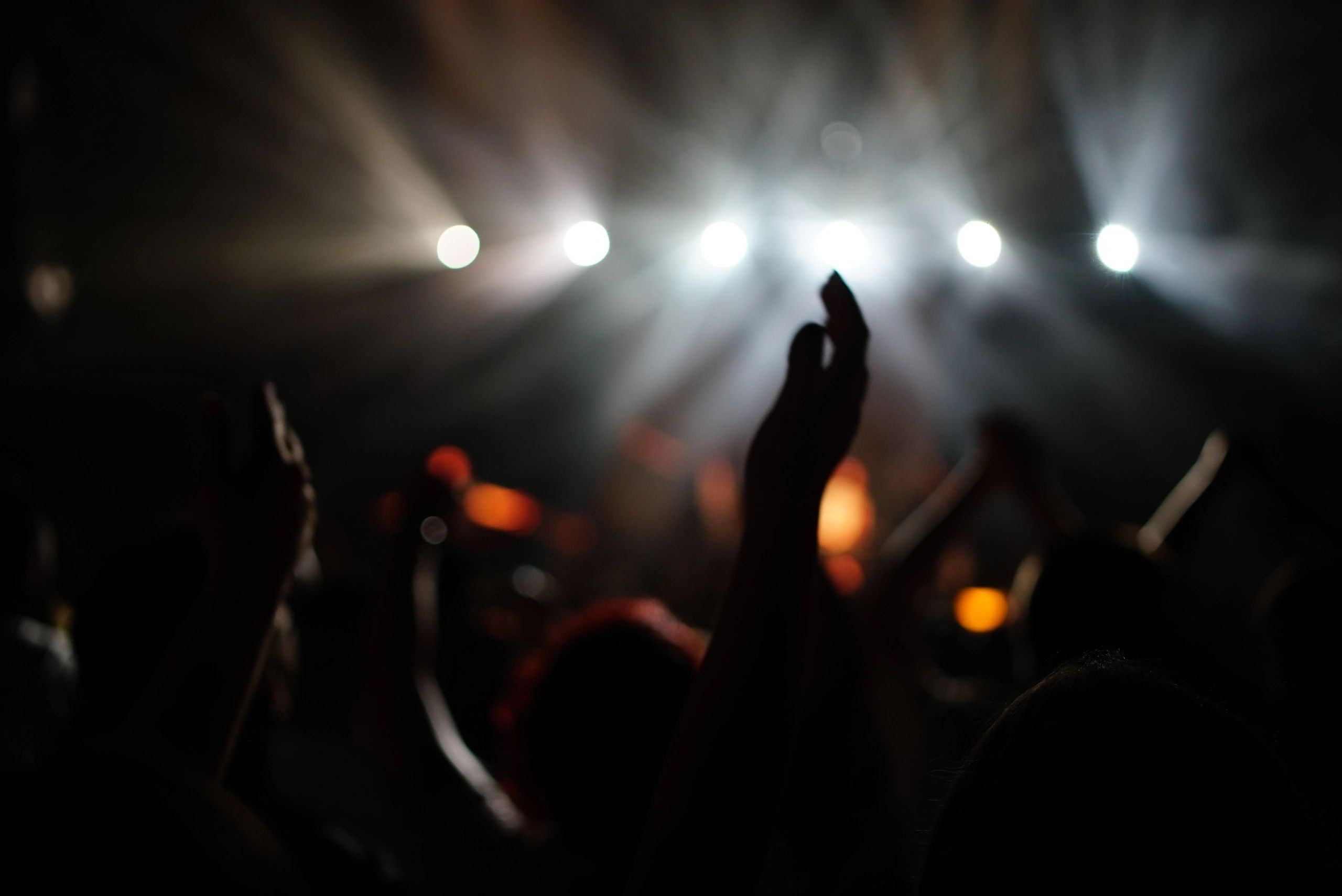 Large gathering with raised hands during worship